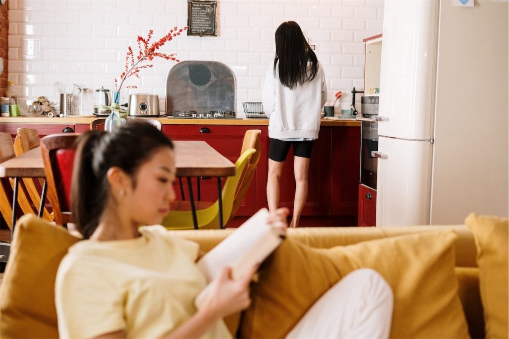 Two women in their fully furnished BUC house that was recently completed.