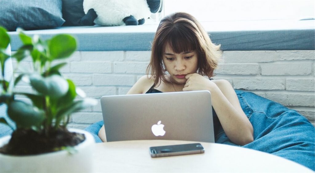 Woman with her laptop researching on her home loan renewal